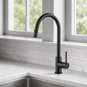 Noxwell KMMB-7470 matte black kitchen mixer tap installed beside a stainless steel sink